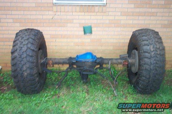Rear axle with large off-road tires and blue differential cover