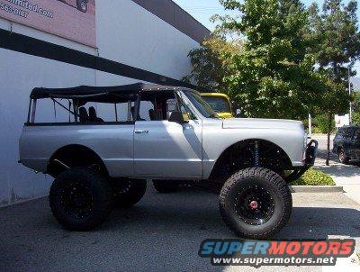 Silver lifted K5 Blazer with soft top, big tires, and custom suspension