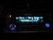 1993 Ford Probe - A Kenwood car stereo displays song information and track time in a dimly lit interior.