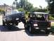 1979 Chevrolet C/K Pickup - A lifted pickup truck is playfully interacting with a Jeep, showing off their off-road capabilities.