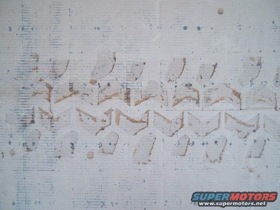 Tire tread impression on a white surface