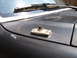 1988 Ford Bronco - Close-up of an antenna mount on the hood of a vehicle, with a windshield wiper in the background.