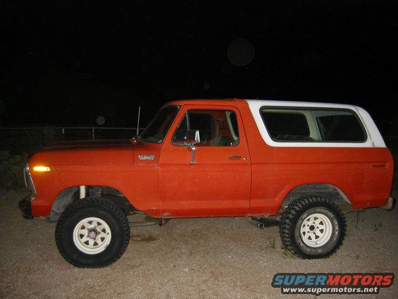 Side view of a 1978 Ford Bronco in orange with a white top