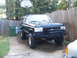 1988 Ford Bronco - This lifted black Ford Bronco is parked in a driveway with a basketball hoop and trash cans nearby.