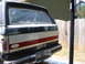 1988 Ford Bronco - Rear view of a 1988 Ford Bronco undergoing paint preparation, showing the taped-off rear window and license plate.