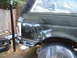 1988 Ford Bronco - The rear of a vehicle is covered in primer and has spray-painted text on the side.