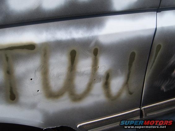 Spray-painted text on vehicle side panel
