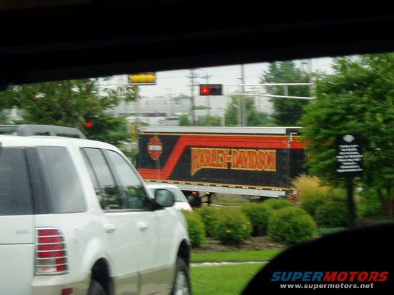 Harley-Davidson trailer driving on the road, seen from a white SUV