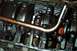1985 Ford Bronco - Close-up view of the engine's crankshaft and connecting rods, covered in oil.