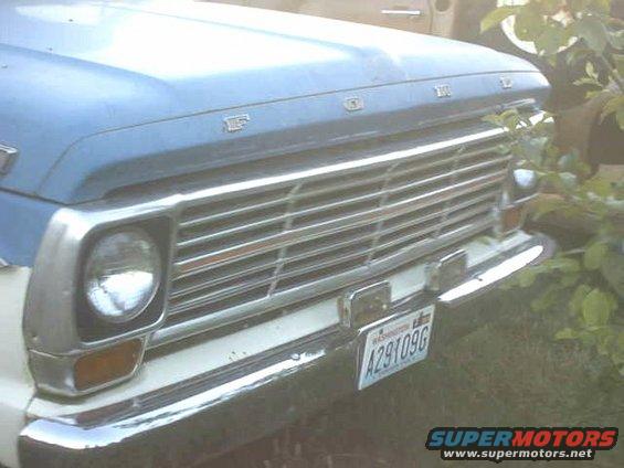 Blue and white Ford F-100 truck front grille and headlight, Washington license plate A291096