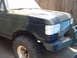 1988 Ford Bronco - This Ford Bronco is undergoing a paint job with a camouflage pattern and has its headlights covered with tape.