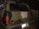 1988 Ford Bronco - Rear view of a camouflaged Ford Bronco with "V.I.L. AIR FORCE" and "DECALKITS.COM" stickers on the rear window.