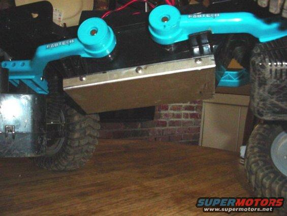 RC crawler chassis with blue Fabtech suspension parts and large tires