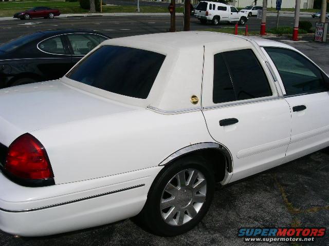 White 2001 Ford Crown Victoria sedan rear quarter view with vinyl roof