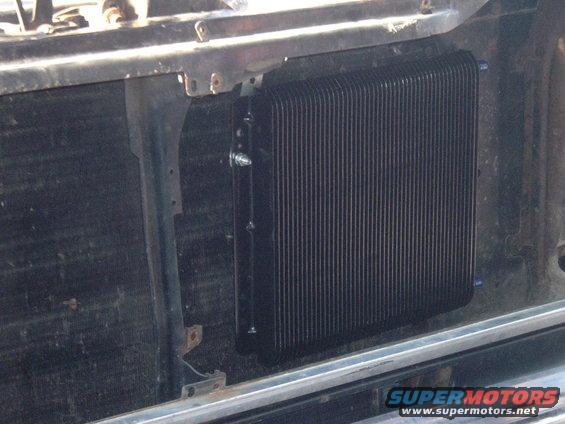 Aftermarket oil cooler mounted in front of a vehicle's radiator