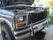 1982 Ford Bronco - Front view of a 1980 Ford Bronco with the hood up, revealing the engine compartment.