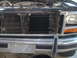 1982 Ford Bronco - Aftermarket transmission cooler mounted in front of the radiator on a vehicle's front end.