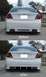 1999 Ford Taurus - Side-by-side view shows a rear bumper modification on a white sedan.
