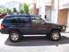 1996 Jeep Grand Cherokee - Side profile of a black 1996 Jeep Grand Cherokee with gold rims.