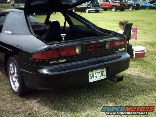 Black 1995 Ford Probe GT with trunk open, showing interior and rear bumper with license plate