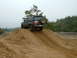 1995 Ford Bronco - Ford Bronco navigates an off-road course, ascending a sandy incline.