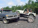 1979 Ford Bronco - A 1977 Ford F-Series truck is parked next to a modified Jeep, both appearing to be off-road vehicles.