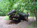 1979 Ford Bronco - This truck is attempting to navigate a challenging off-road obstacle, with its tires angled precariously.