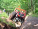 1979 Ford Bronco - Custom off-road buggy navigates a challenging muddy terrain with onlookers present.