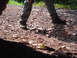 1979 Ford Bronco - A person stands on a rocky path, with a discarded metal object lying nearby.