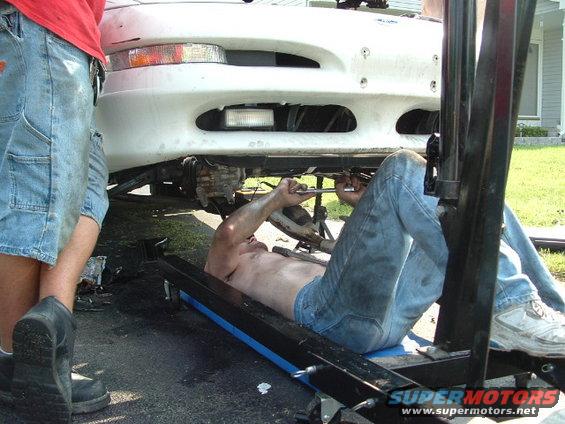 1996 Ford Probe front end with man working underneath