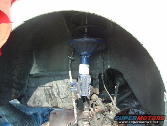 Front wheel well and suspension components with blue shock absorber