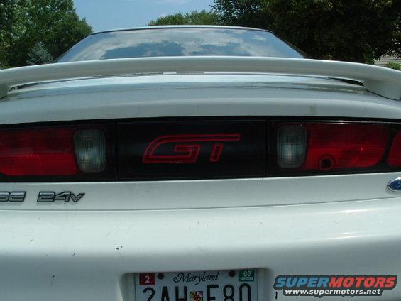 White car rear with GT badge and 24V emblem