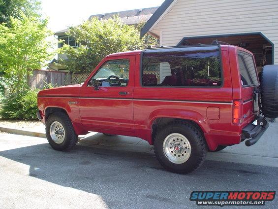 Red 1988 Ford Bronco II parked on a street, side view