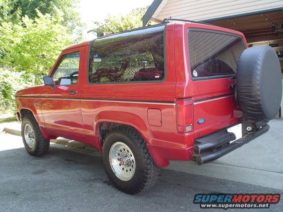 Red 1988 Ford Bronco II rear quarter view with spare tire mounted on rear door