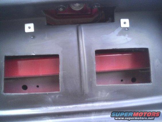 Rear bumper area with red inner structure visible through cutouts