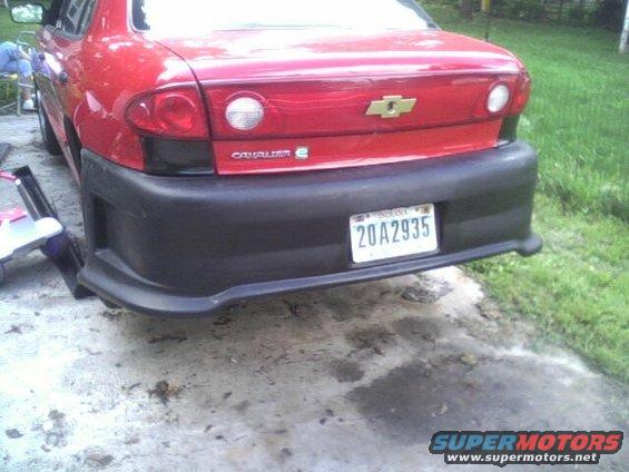 2005 Chevrolet Cavalier rear bumper with license plate 20A2935. Aftermarket black bumper installed