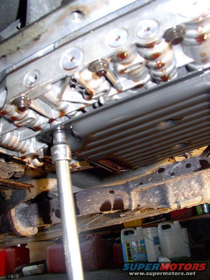 There's the third and last filter bolt coming off, here's comes some more ATF.