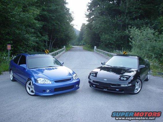 Black Ford Probe and blue Honda Civic parked on a bridge