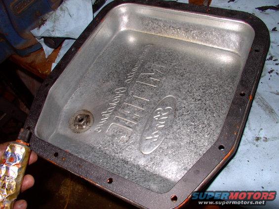 Same story with the new pan gasket. Just to the pan, not to the trans as well ( or it'll be Hell on earth getting it off next time). Yes you are correct, that pan drain bolt wasn't there when I started, it's been added. Read up on that elsewhere on the site.