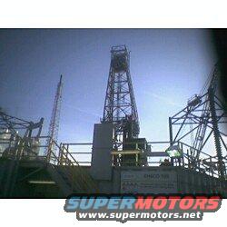 Oil rig against a clear blue sky, with multiple levels and structures