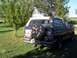 1987 Ford Bronco - This Ford Bronco is parked outdoors on a sunny day, with trees and grass surrounding it.
