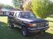 1987 Ford Bronco - This 1987 Ford Bronco is shown from a three-quarter front angle, parked on a grassy lawn.