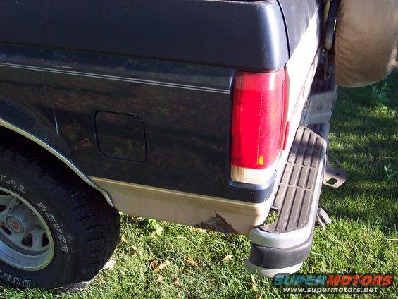 Rear corner of 1987 Ford Bronco with visible rust on the lower body panel