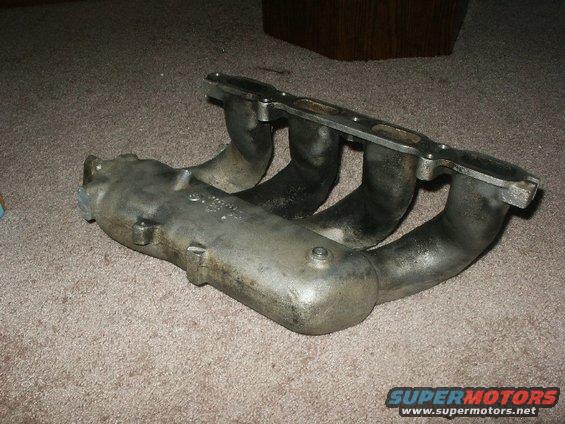 Exhaust manifold with four pipes. Some text is visible on the side