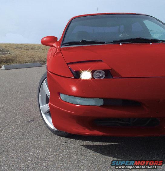 Red 1993 Ford Probe front view with pop-up headlights