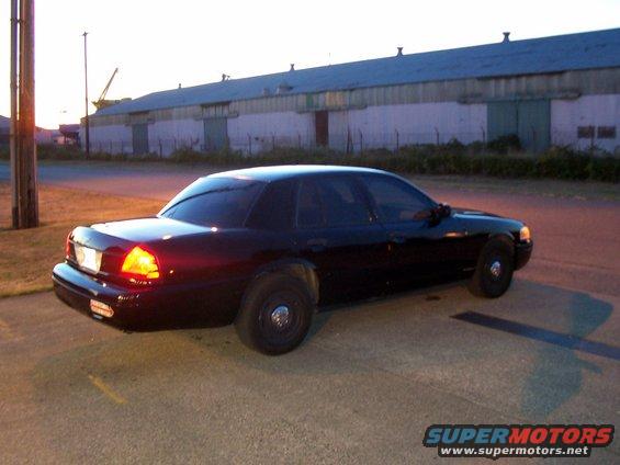 Black 2003 Ford Crown Victoria parked on asphalt, rear quarter view