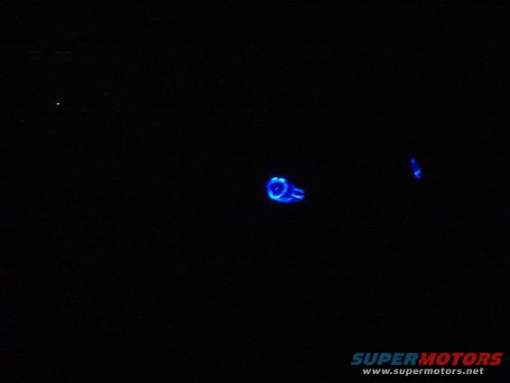 blue glowing car part with text 'SUPERMOTORS' at bottom right