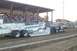 1994 Ford F-150 - A black pickup truck tows a "TERMINATOR" branded trailer during a pull event with spectators in the background.