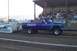 1994 Ford F-150 - A modified pickup truck competes in a pulling event, with spectators in the background.