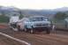 1994 Ford F-150 - Pickup truck and trailer on a dirt track with mountains in the background.